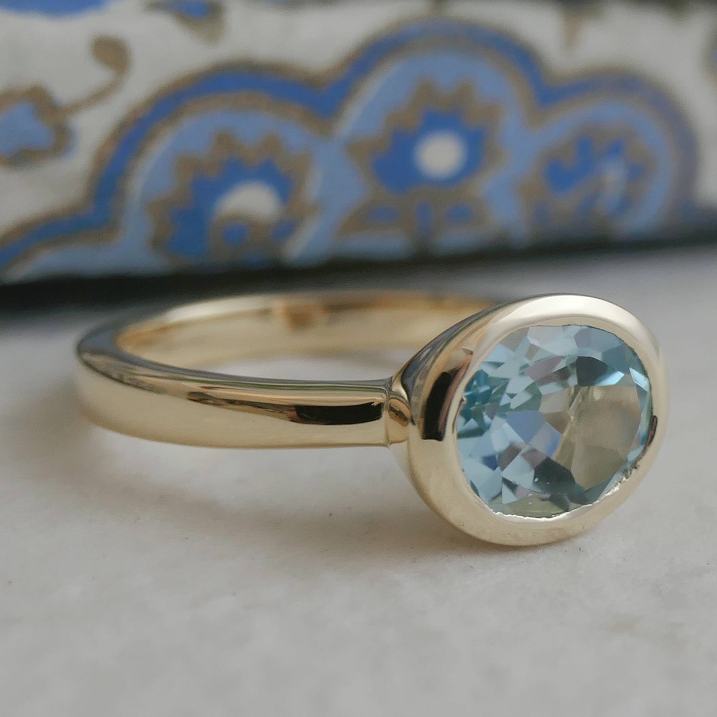 8x10mm Oval Blue Topaz Gold Plated Sterling Silver Ring