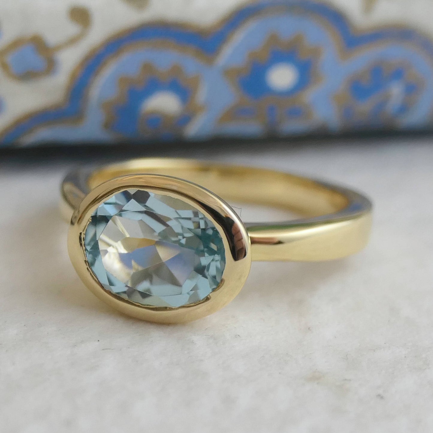 8x10mm Oval Blue Topaz Gold Plated Sterling Silver Ring