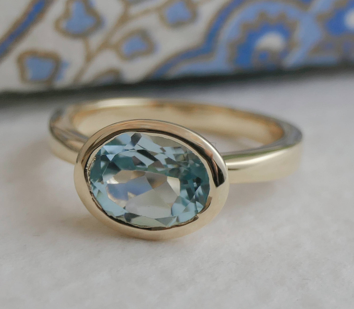 8x10mm Oval Blue Topaz Gold Plated Sterling Silver Ring