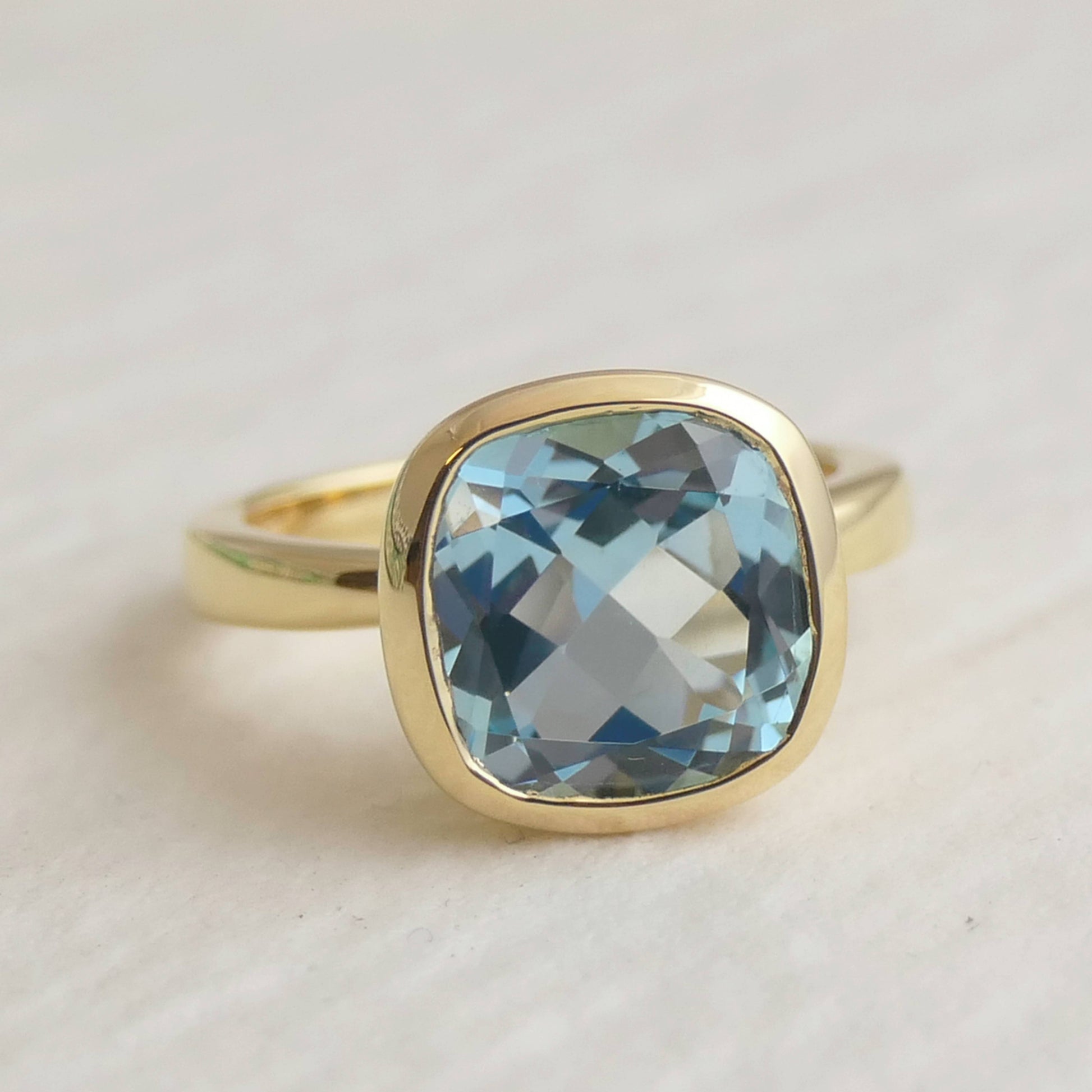 10mm Cushion Cut Blue Topaz Gold Plated Sterling Silver Ring